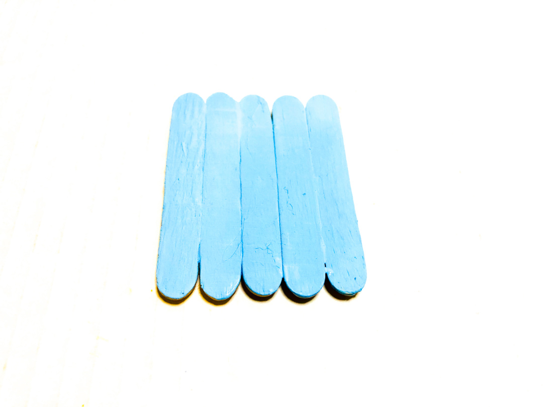 light blue painted popsicle sticks